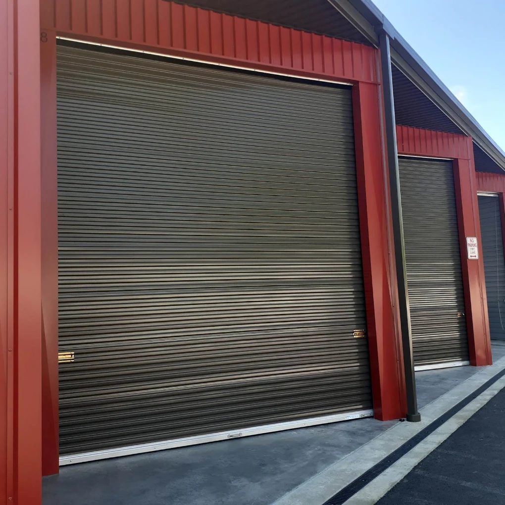 Red roll-up storage door units maintained by New Generation Storage Builders